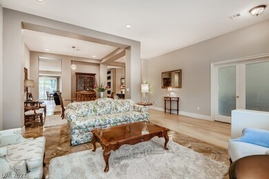 Living room with glass doors to office