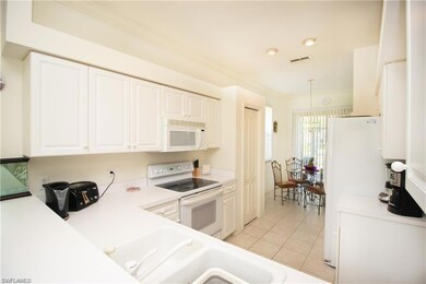 Kitchen with light tile patterned floors, crown mo