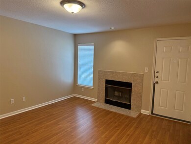 Unfurnished living room with a tile fireplace, a 