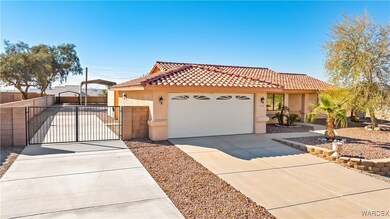 View of front of house with stucco siding, a gate,