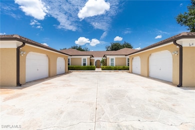 View of front facade with stucco siding and a gara
