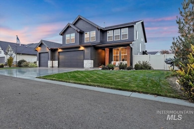 View of front of house featuring concrete driveway, a garage, and stone siding