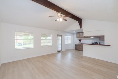 Spacious living room with sleek neutral-toned vinyl plank flooring