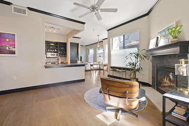 Living area with ceiling fan, visible vents, a gl
