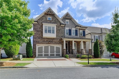 Craftsman inspired home featuring driveway, a gara