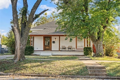 View of front of home with covered porch and roof with shingles