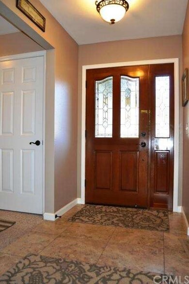 The tiled formal entry inside the home welcomes yo