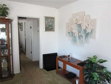 View of the living room leading to hallway and bed