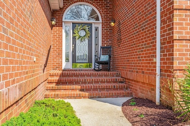 Entrance to property featuring brick siding