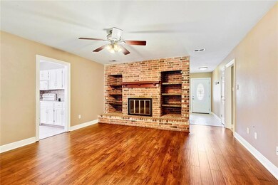 View of the Den with wood burning Fireplace from t