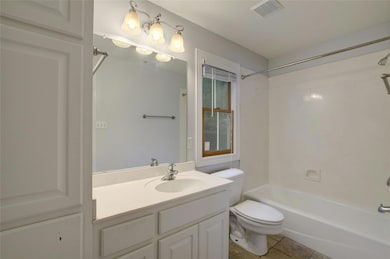 Full bathroom featuring toilet,  shower combinati