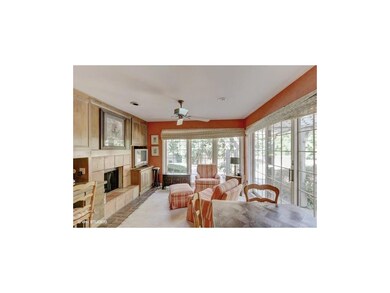 Hearth room  with walls of windows overlooking bri
