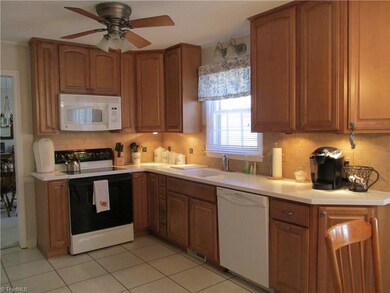 Updated kitchen with solid surface counters.