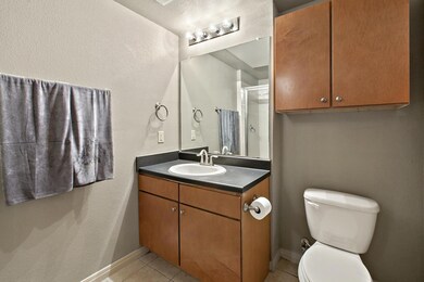 Full bathroom with toilet, tile patterned floors,