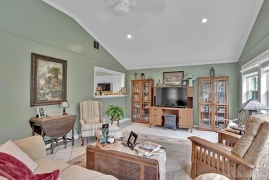 Tiled living room with ornamental molding and loft