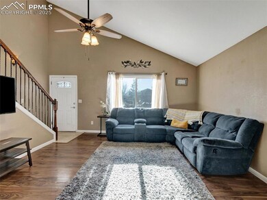 Living room with ceiling fan, dark hardwood / wood