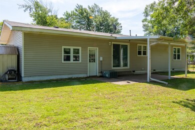 Back view. Covered patio. Sliding glass doors from