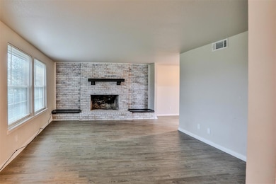Unfurnished living room featuring hardwood / wood-
