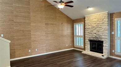 Unfurnished living room featuring a ceiling fan, 