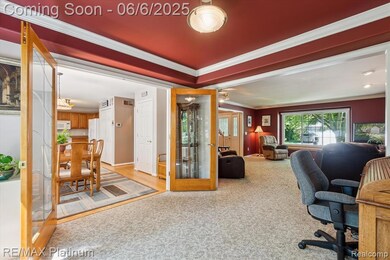 Spacious layout with rich tones, glass French doors, and a cozy view-filled living area.