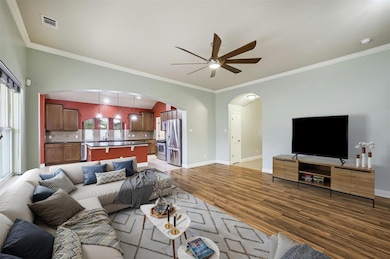 Living room featuring visible vents, arched walkw