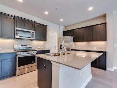 Kitchen featuring stainless steel appliances, lig