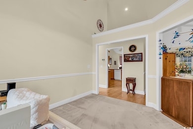 Dining room featuring light carpet and  molding