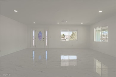 Foyer entrance with light marble finish floors, re