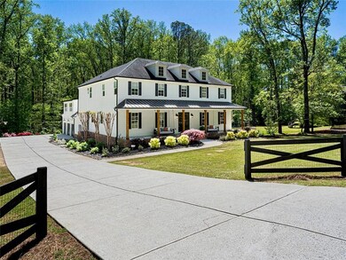 View of front of house featuring fence, a front la