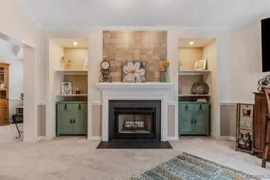 Living room with crown molding, light carpet, and