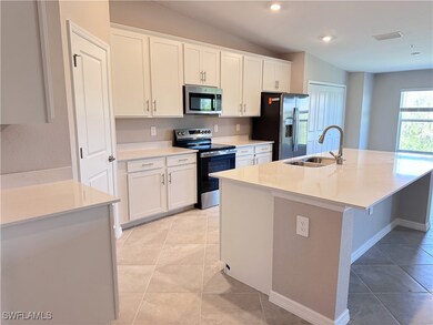 Kitchen featuring stainless steel appliances, a si