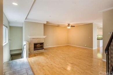 Gas, tile fireplace with L-shaped mantle for displ