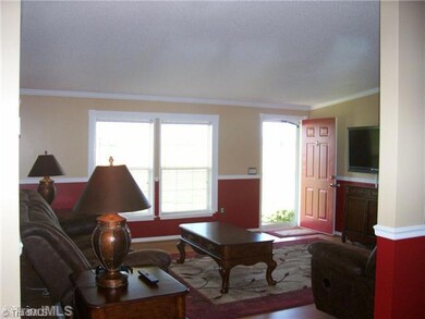 Living Room. Living Room has lots of lighting from windows and enjoyment of the beautiful view across the rolling 3 Ac to a breathtaking mountain view. Pay attention to detail of Crown and Chair Molding. Room size: 14 8