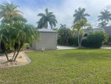 View of grassy yard with an outdoor structure