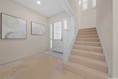 An inviting entrance foyer, marble floors and stai