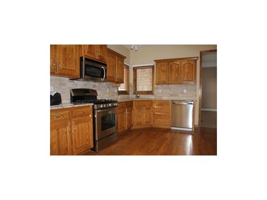 remodeled kitchen with new granite counter, tumble