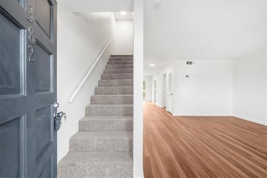 Staircase with recessed lighting, baseboards, and wood finished floors