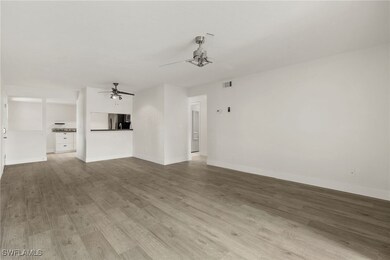 Unfurnished living room featuring wood finished fl