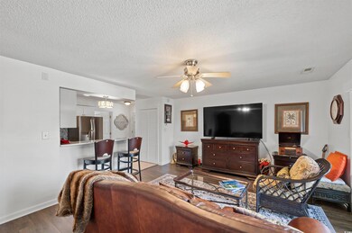 Living room featuring a textured ceiling, dark woo