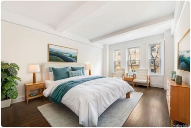Bedroom with dark wood-type flooring and beamed ceiling