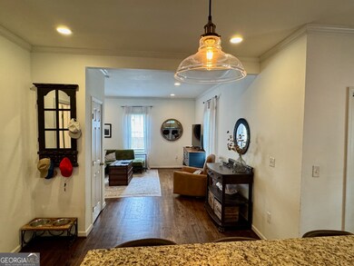 Gleaming floors and living space open to the kitch