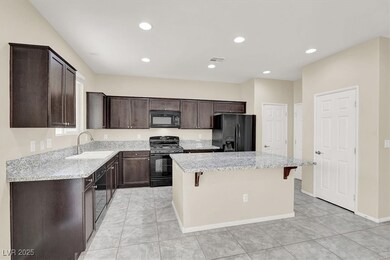 Kitchen featuring black appliances, a sink, a kitc