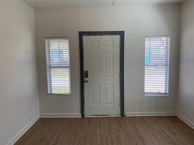 View of living toward front door...more windows!