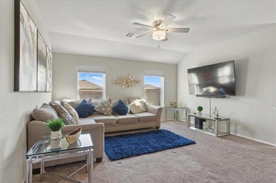 Carpeted living room with ceiling fan