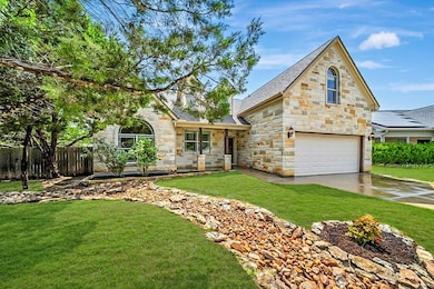 View of front facade with stone siding, an attach