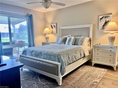 Queen Bed featuring tile plank floors, ceiling fan with ensuite bathroom