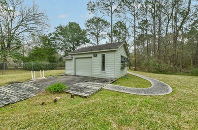 As you stroll along the pathway from the main house toward the pond and golf lane behind the home, this gardeners' shed houses the well pump for the yard irrigation and pond, as well as providing space for yard equipment and gardening tools.