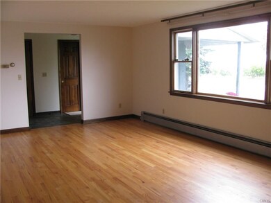 Oversized living room with hardwoods. Large window