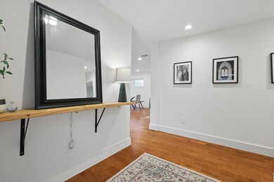 Hallway featuring baseboards, wood finished floors