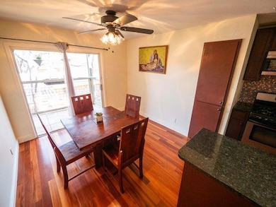 Dining space featuring dark wood-style floors and